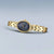 Bering Damenuhr mit goldenem Metallarmband und dunkelblauem Zifferblatt, getragen wirkende Ansicht