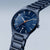 Bering Herrenuhr mit blauem Zifferblatt, Titan-Armband und orangefarbenem Sekundenzeiger