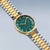 Bering Herrenarmbanduhr Schrägansicht mit grünem Zifferblatt und Gold-Silber-Gliederband