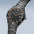 Bering Solaruhr mit schwarzem Zifferblatt, orangefarbenem Akzent und Metallarmband