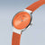 Bering Uhr: rundes orangefarbenes Zifferblatt mit Indexen, orangefarbenes Mesh-Armband