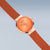 Bering Damenuhr am Milanaise-Armband, orangefarbenes Zifferblatt, roségold