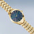 Bering Solar Damenuhr mit goldfarbenem Armband und dunkelblauem Zifferblatt, seitliche Krone