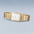 Bering Damenuhr am Handgelenk: rechteckiges goldfarbenes Gehäuse, Metallgliederarmband, weißes Zifferblatt