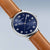 Bering Herrenuhr mit blauem Zifferblatt, silberner Gehäusekante und braunem Lederband