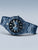 Bering Herrenarmbanduhr seitlich schräg, blaues Zifferblatt mit Datumsfenster, Metallarmband