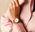Damenuhr Danish Design am Handgelenk mit rotem Lederarmband und weißem Zifferblatt