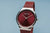 Bering Damenarmbanduhr mit rotem Zifferblatt und Milanaiseband, Gehäuse silberfarben
