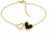 Guld-armband med två hjärtformade hängen, svart hjärta med Hilfiger-logotyp.