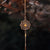 Guldpläterat armband med mandalaformat hänge på en fin kedja
