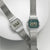 Zwei Casio Vintage Uhren mit silbernem Mesh-Armband und grüner LCD-Anzeige