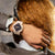 G-Shock damklocka med beige armband och mörk urtavla i sidovy