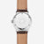 Unisex-armbandsur med silverfärgat hölje, brunt läderarmband och radiellt urtavla