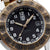 Luminox Herrenarmbanduhr im Detail: schwarzes Zifferblatt, Datumsfenster, braun-goldene Lünette