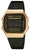 Digital vintageklocka med guldfärgad infattning, svart metallband och digital display