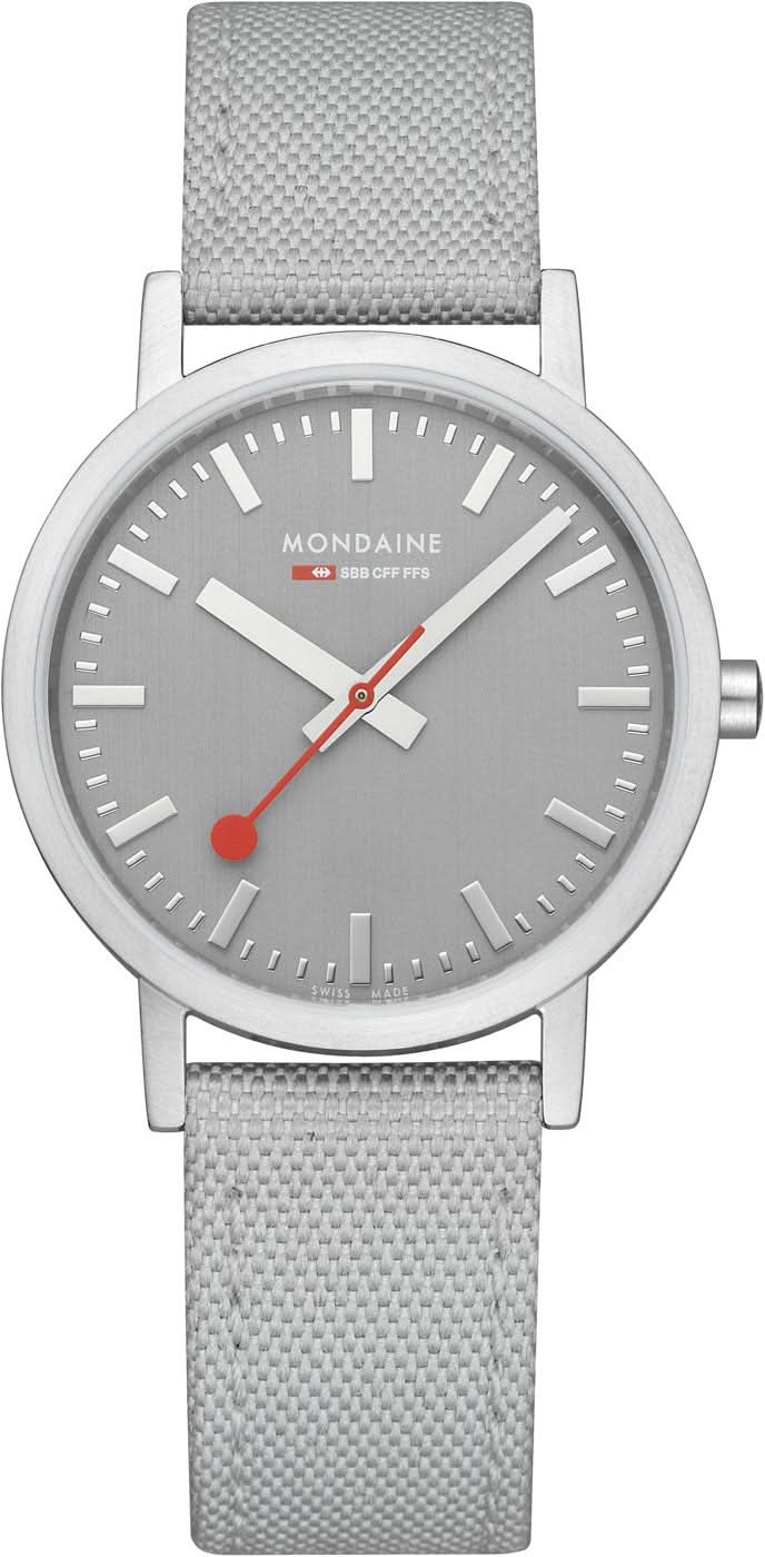Unisex-armbandsur med grått textilband, silverfärgat hölje och grå urtavla.
