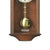 Nussbaumfarbene Wanduhr mit weißem Ziffernblatt und goldfarbener Pendelkugel