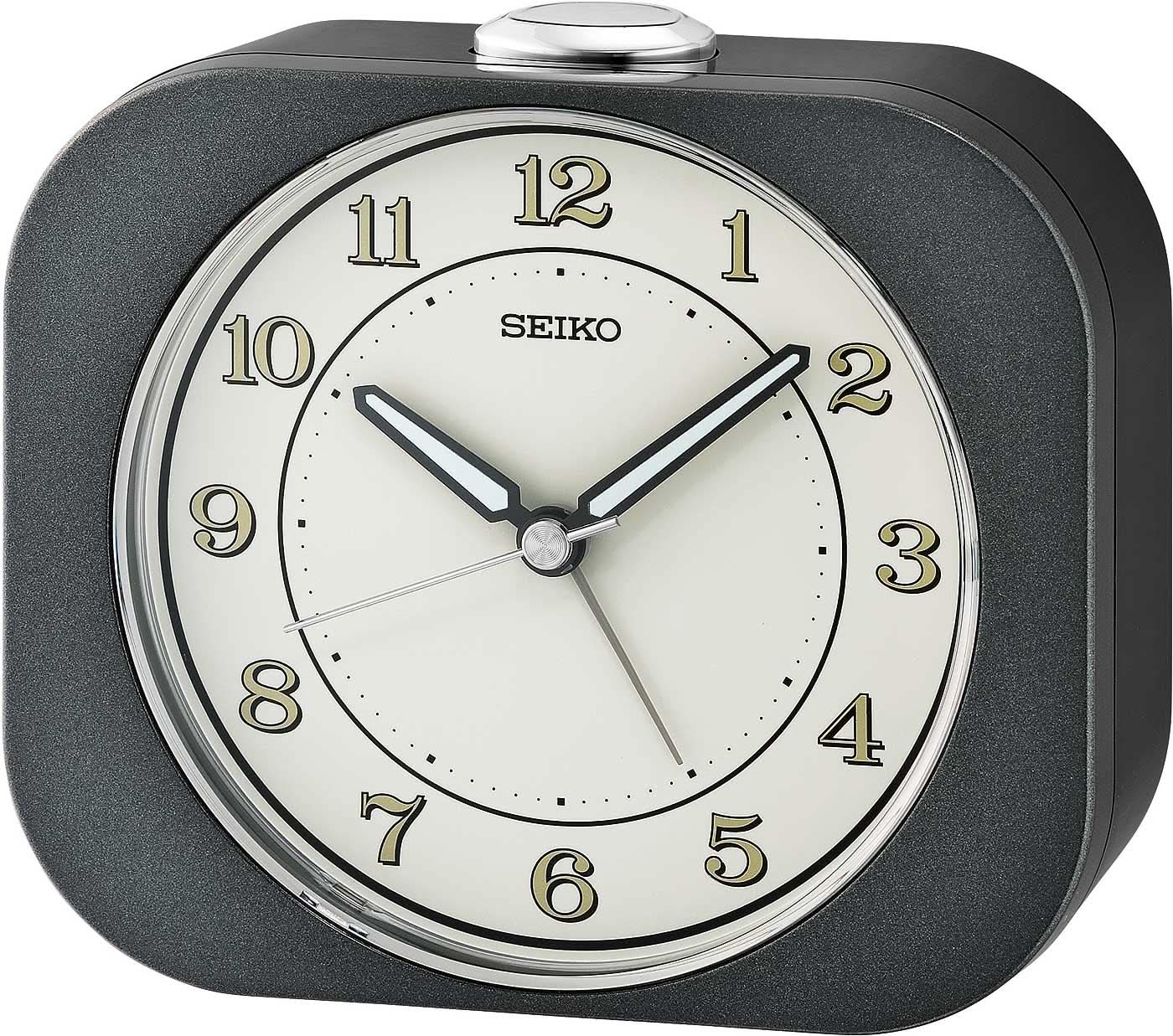 Analog Seiko-väckarklocka med rund vit urtavla och mörkt plasthölje